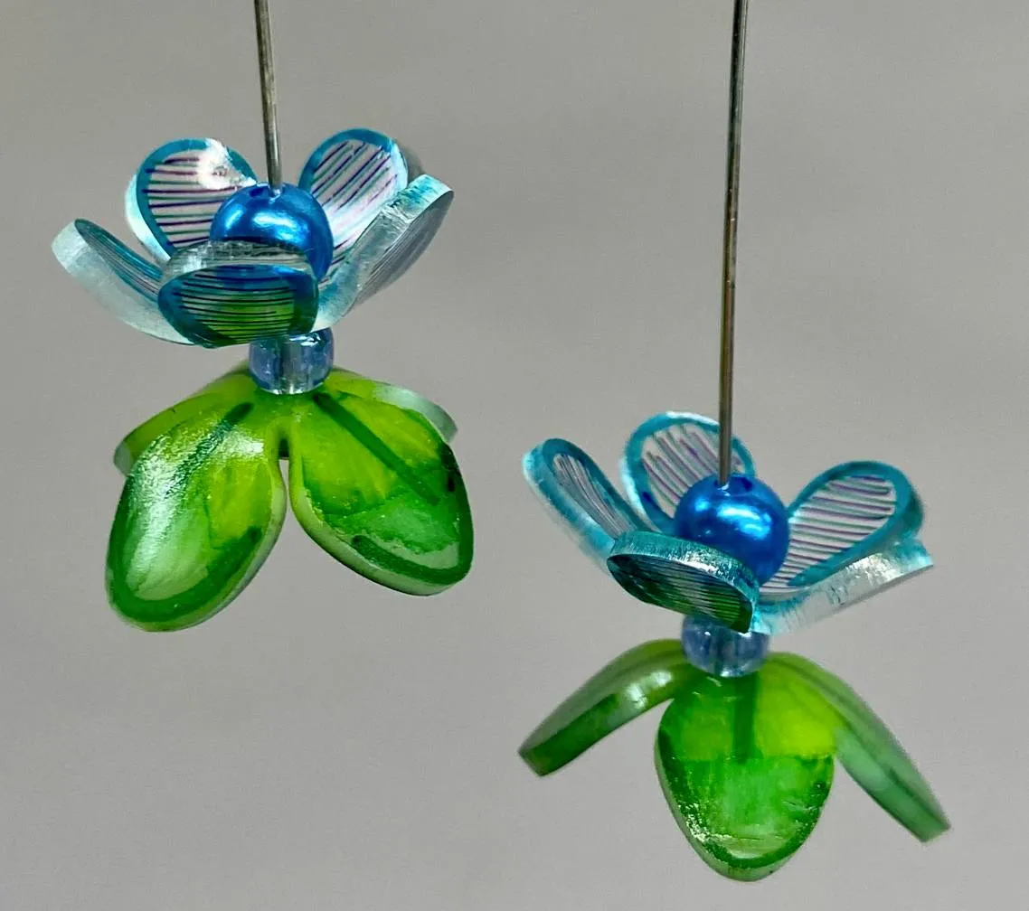 A pair of colorful heat shrink earrings.